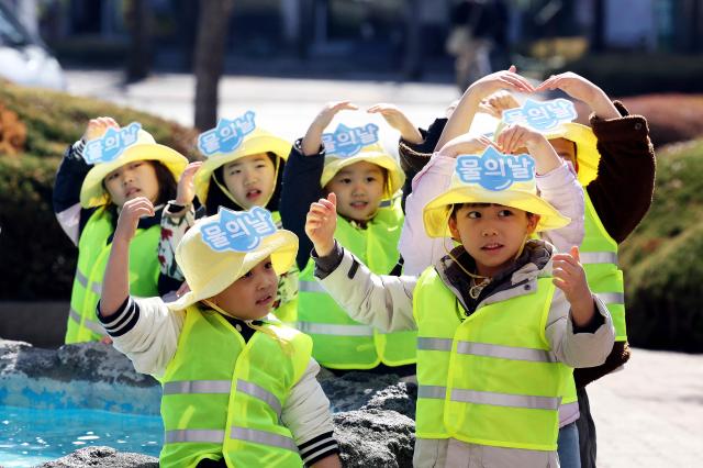 Children perform a demonstration highlighting the importance of water at the Buk-gu District Office plaza in Gwangju on Mar 19 2026