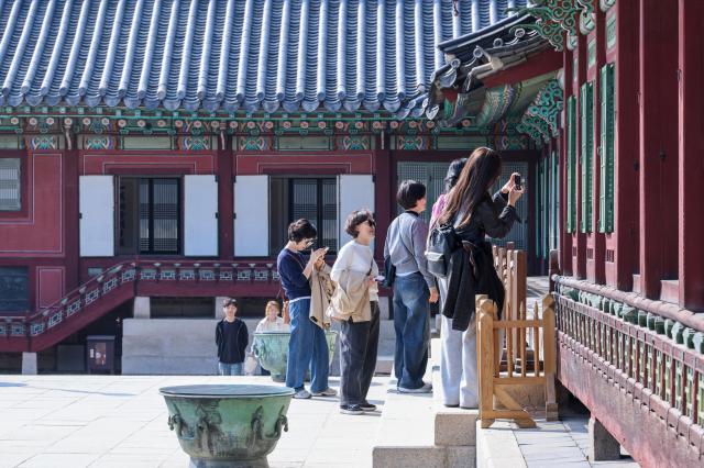 Visitors look inside a building at Changdeokgung Palace in Jongno District Seoul March 25 2026