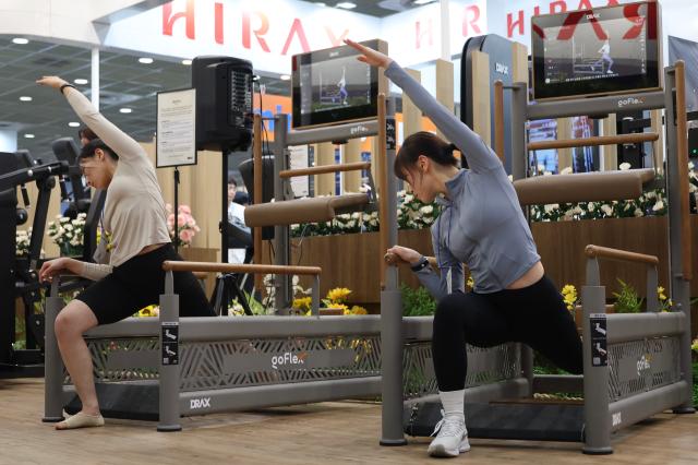 Officials demonstrate stretching at SPOEX 2026 at COEX in Samseong-dong Gangnam-gu Seoul March 26 2026 AJP Han Jun-gu
