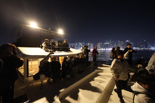 Visitors enjoy the night view aboard a yacht in Suyeong-gu Busan March 28 2026 AJP Han Jun-gu