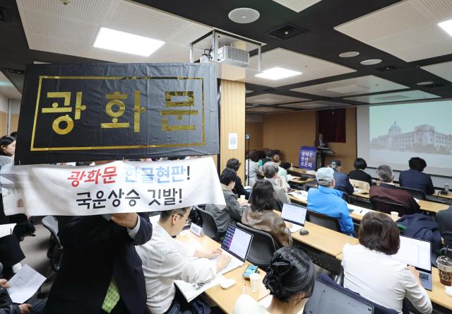 31일 서울 종로구 대한민국역사박물관에서 열린 광화문 현판 토론회에서 한 참석자가 한글로 쓴 광화문 문구를 들고 있다 이번 토론회는 광화문 한글 현판 추가 설치에 대한 주요 입장 및 논거를 위해 마련됐다 사진연합뉴스