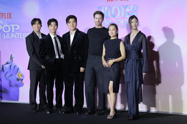 IDO (Lee Yoo-han, Kwak Jung-gyu, Nam Hee-dong), directors Maggie Kang and Chris Appelhans, and composer EJAE (Lee Jae)