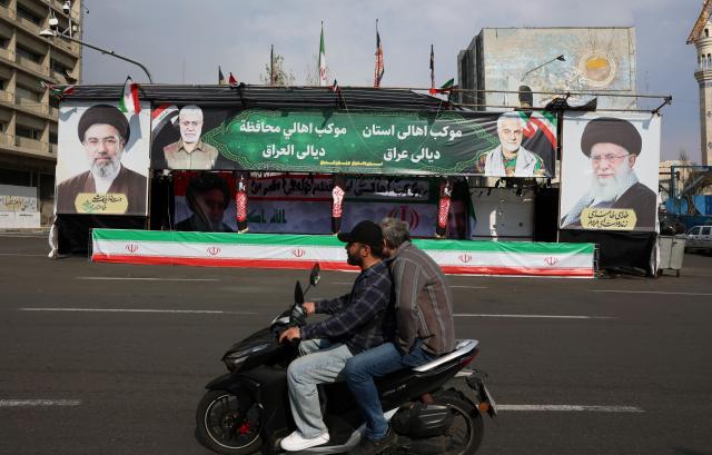 Men drive a motorcycle past billboards of Iranian Supreme Leader Ayatollah Mojtaba Khamenei L and his late father former Iranian Supreme Leader Ayatollah Ali Khamenei R in a street in Tehran Iran March 31 2026 A joint Israeli and US military operation launched on February 28 continues to target multiple locations across Iran EPA-Yonhap 