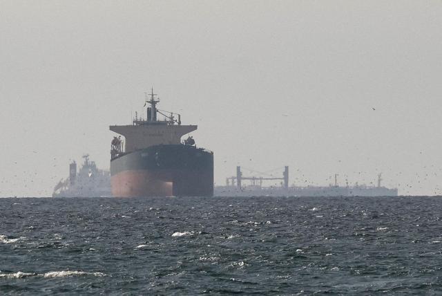 Cargo ships are seen in the Gulf waters near the Strait of Hormuz as viewed from northern Ras Al Khaimah adjacent to Omans Musandam Governorate in this undated photo Reuters