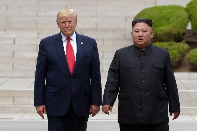 US President Donald Trump left meets with North Korean leader Kim Jong-un at the North Korean side of the border at the village of Panmunjom in the Demilitarized Zone on June 30 2019 AP-Yonhap