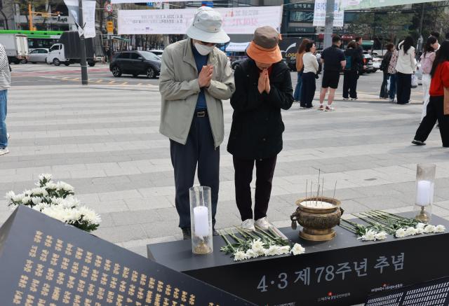 Citizens observe a moment of silence after laying flowers at a memorial for victims of the Jeju April 3 Incident at Songhyeon Square in Jongno-gu Seoul on the 78th anniversary April 3 2026 Yonhap
