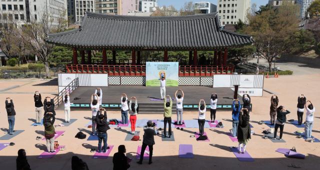 Participants take part in an outdoor yoga session during Seoul Yoga Connect 2026 at Namsangol Hanok Village in Seoul on April 7 2026 ahead of the International Day of Yoga AJP Han Jun-gu