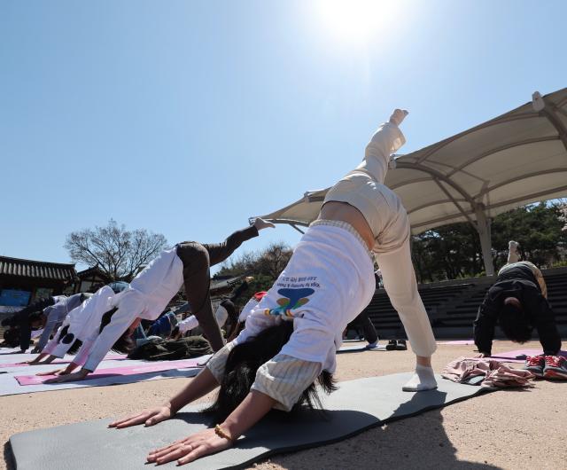 Participants take part in an outdoor yoga session during Seoul Yoga Connect 2026 at Namsangol Hanok Village in Seoul on April 7 2026 ahead of the International Day of Yoga AJP Han Jun-gu