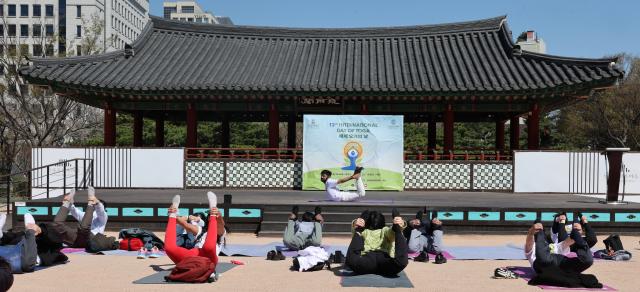 Participants take part in an outdoor yoga session during Seoul Yoga Connect 2026 at Namsangol Hanok Village in Seoul on April 7 2026 ahead of the International Day of Yoga AJP Han Jun-gu