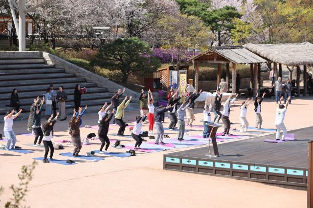 Participants take part in an outdoor yoga session during Seoul Yoga Connect 2026 at Namsangol Hanok Village in Seoul on April 7 2026 ahead of the International Day of Yoga AJP Han Jun-gu