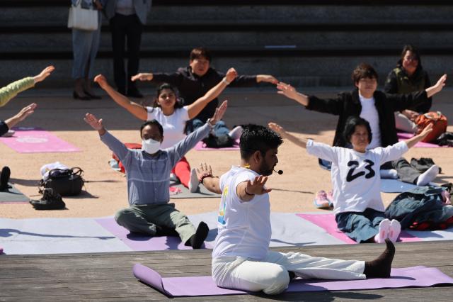 Ashish Singh a yoga teacher at the Swami Vivekananda Cultural Centre SVCC leads participants during an outdoor yoga session at Namsangol Hanok Village in Seoul on April 7 2026 ahead of the International Day of Yoga AJP Han Jun-gu
