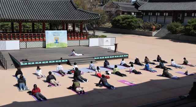 Participants take part in an outdoor yoga session during Seoul Yoga Connect 2026 at Namsangol Hanok Village in Seoul on April 7 2026 ahead of the International Day of Yoga AJP Han Jun-gu