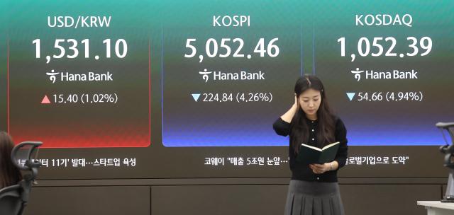 Traders work at Hana Bank’s dealing room in Seoul on Tuesday March 31 2026 as the benchmark KOSPI retreated for a fourth consecutive session to the 5050 level amid heightening uncertainties over the conflict in Iran Yonhap
