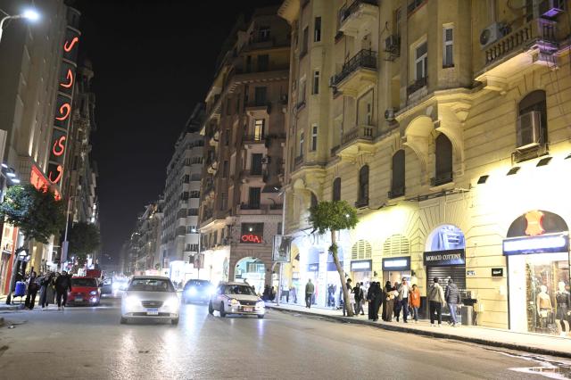 People walk before the closing of shops in downtown Cairo on April 2 2026 AFP-Yonhap 