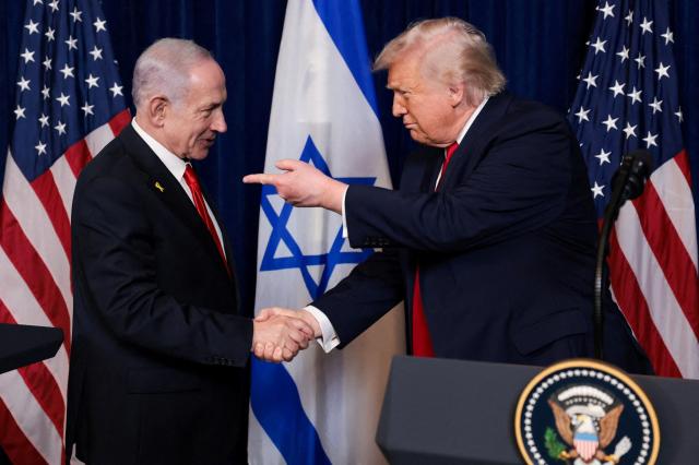 US President Donald Trump points his finger towards Israeli Prime Minister Benjamin Netanyahu as they shake hands during a press conference after meeting at Trumps Mar-a-Lago club in Palm Beach Florida US December 29 2025 Reuters-Yonhap 