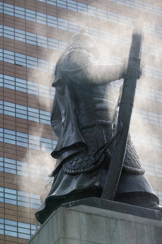 A statue of Yi Sun-sin is cleaned by Seoul Metropolitan Government officials at Gwanghwamun Square in central Seoul on April 14 2026 AJP Yoo Na-hyun
