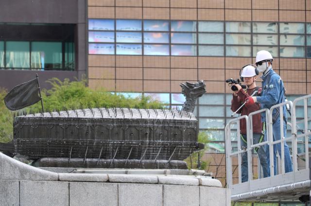 A statue of Yi Sun-sin is cleaned by Seoul Metropolitan Government officials at Gwanghwamun Square in central Seoul on April 14 2026 AJP Yoo Na-hyun
