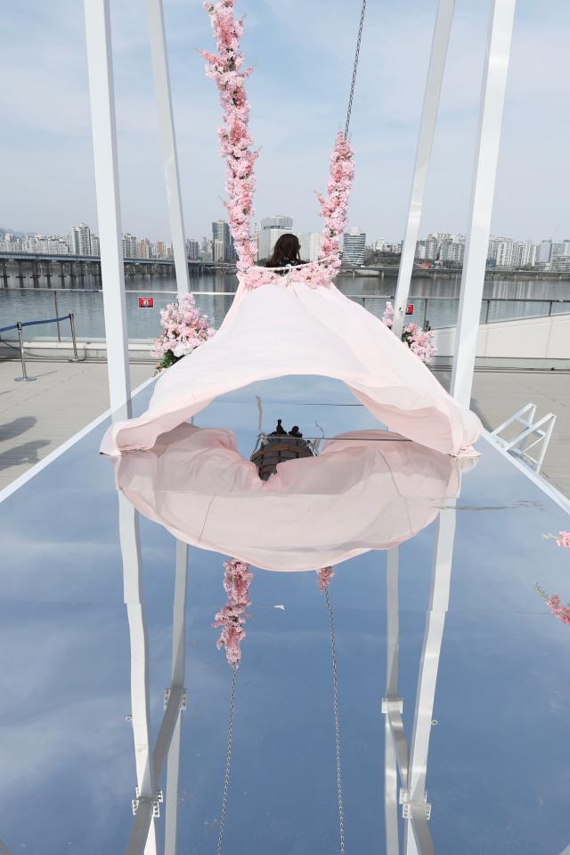 A visitor rides a swing on the rooftop of the Han River Bus Dock at Yeouido Hangang Park Yeongdeungpo-gu Seoul April 14 2026 AJP Han Jun-gu