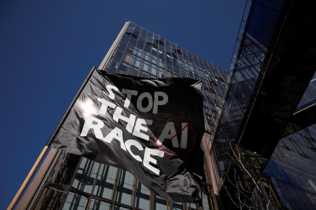 2026년 3월 21일 미국 캘리포니아주 샌프란시스코에서 열린 시위에서 AI 경쟁을 멈춰라라는 문구가 적힌 깃발이 펄럭이고 있다 시위대는 AI 개발 중단을 요구했다