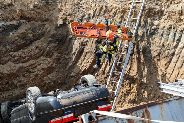 Firefighters take part in a rescue drill simulating a sinkhole that buried vehicles during a joint disaster response exercise at a construction site in the Gyosan public housing district in Cheonhyeon-dong Hanam Gyeonggi Province on April 15 2026 AJP Yoo Na-hyun
