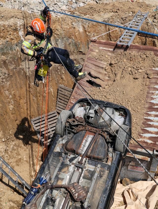 Firefighters take part in a rescue drill simulating a sinkhole that buried vehicles during a joint disaster response exercise at a construction site in the Gyosan public housing district in Cheonhyeon-dong Hanam Gyeonggi Province on April 15 2026 AJP Yoo Na-hyun
