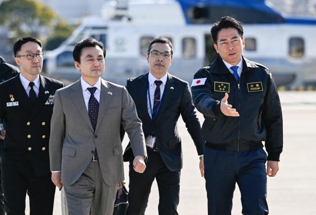 South Korean Defense Minister Ahn Gyu-back second from left arrives at the Japan Maritime Self-Defense Force’s Yokosuka District Headquarters on March 30 2026 and is escorted by Japanese Defense Minister Shinjiro Koizumi fourth from left Courtesy of the Ministry of National Defense