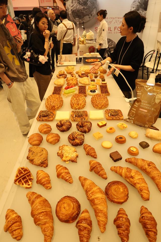 A booth staff member introduces bread products at the 2026 Korea International Bakery Fair held at COEX in southern Seoul on April 17 2026 AJP Han Jun-gu