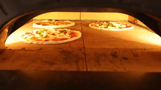 Pizzas are baked in a wood-fired oven at the 2026 Korea International Bakery Fair held at COEX in southern Seoul on April 17 2026 AJP Han Jun-gu