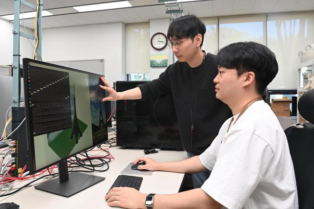 ETRI 연구진이 USD 기반 미디어 트랜스포메이션 기술 시연 화면을 보며 개발 내용을 논의하고 있다 사진ETRI