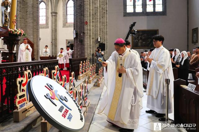지난 19일 명동대성당에서 열린 ‘2027 서울 세계청년대회 본당 도약 미사’에서 정순택 대주교가 WYD 로고 조형물에 성수를 뿌리며 축복하고 있다 이날 미사를 계기로 본당 단위의 준비가 본격화됐다사진천주교서울대교구