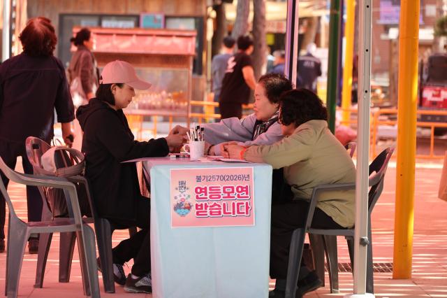A visitor registers for lantern fundraising at Jogyesa Temple in Jongno-gu Seoul April 22 2026 AJP Han Jun-gu