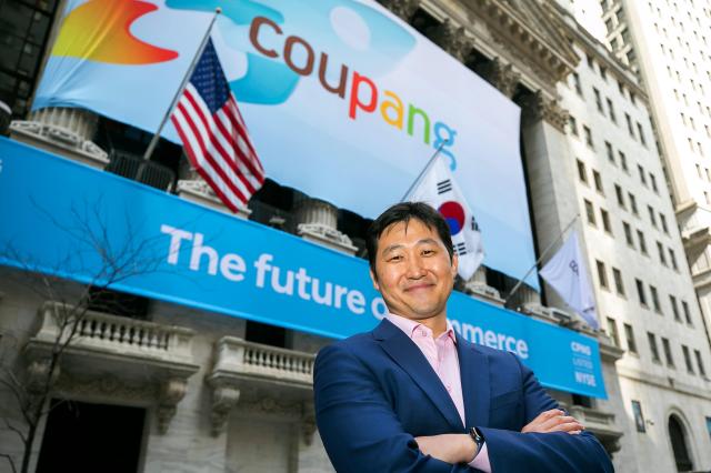 Kim Beom-seok, chair of Coupang’s board, poses in front of the New York Stock Exchange. Photo provided by Coupang.