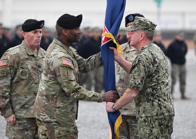 Incoming commander Gen Xavier Brunson center left receives the United States Forces Korea flag from US Navy Adm Samuel John Paparo commander of the United States Indo-Pacific Command during a change-of-command ceremony for the United Nations Command Combined Forces Command and the United States Forces Korea at Camp Humphreys in Pyeongtaek on Dec 20 2024 AP-Yonhap