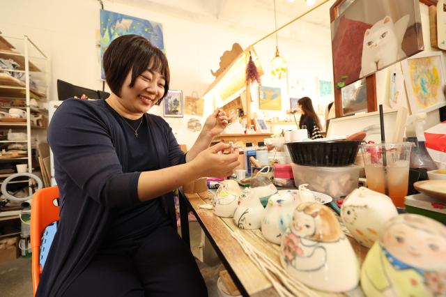 A shop owner assembles ceramic bells they created at the Icheon Ceramic Festival held in Sindun-myeon Icheon April 29 2026 AJP Han Jun-gu