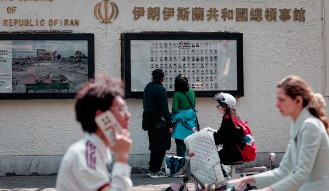 People look at a poster with pictures of child war casualties on display on the wall of the Iranian consulate in Shanghai China 30 April 2026 A missile struck the Shajareh Tayyebeh girls elementary school in Minab in southern Iran during a joint US-Israeli military operation on February 28 2026 This strike caused one of the highest civilian death tolls in the conflict with reports of 165 to 175 fatalities including over 100 schoolgirls aged seven to 12 according to Iranian officials EPA-Yonhap 