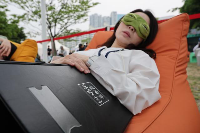 A participant sleeps at the 2026 Han River Napping Championship held at Mulbit Plaza in Yeouido Hangang Park Yeongdeungpo-gu Seoul May 2 2026 AJP Han Jun-gu