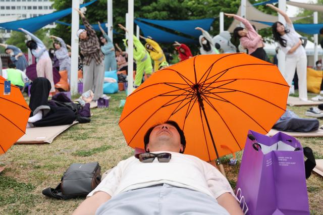 A participant sleeps at the 2026 Han River Napping Championship held at Mulbit Plaza in Yeouido Hangang Park Yeongdeungpo-gu Seoul May 2 2026 AJP Han Jun-gu