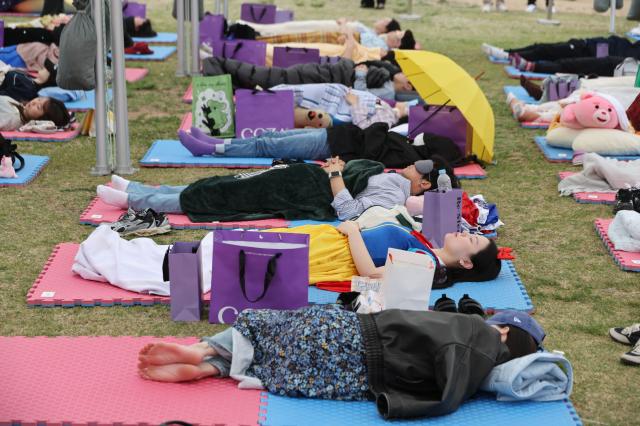 Participants sleep at the 2026 Han River Napping Championship held at Mulbit Plaza in Yeouido Hangang Park Yeongdeungpo-gu Seoul May 2 2026 AJP Han Jun-gu