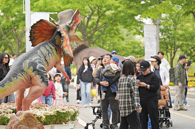해남공룡대축제 현장에서 관광객들이 어린 아이와 동작공룡를 구경하고 있다사진해남군