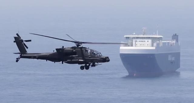 An Apache helicopter carrying US Central Command chief Brad Cooper flies over waters near the Strait of Hormuz on May 3 Screenshot from US Central Command’s X account