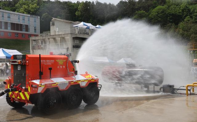 Unmanned firefighting robot FIRO demonstrates water spraying at the unmanned firefighting robot naming ceremony and demonstration held at Gyeonggi Fire Service Academy in Yongin Gyeonggi Province May 7 2026 AJP Han Jun-gu
