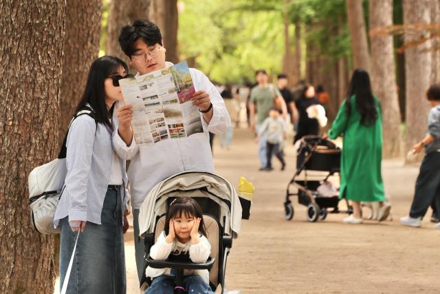 Visitors look at a map at the Nami Island International Childrens Book Festival held on Nami Island in Chuncheon Gangwon Province May 10 2026 AJP Han Jun-gu