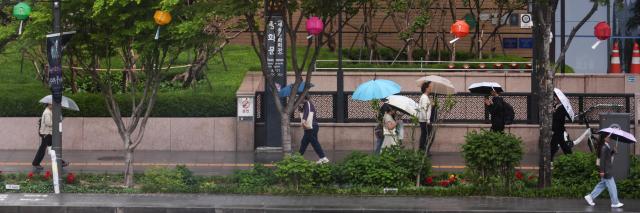 Citizens walk with umbrellas in Gwanghwamun central Seoul during rainfall on May 11 2026 AJP Yoo Na-hyun