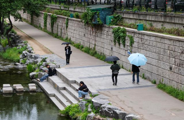 Citizens walk with umbrellas along Cheonggyecheon Stream in Seoul during rainfall on May 11 2026 AJP Yoo Na-hyun


