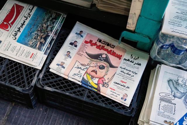 The front page of the Sunday May 10 2026 edition of Iranian newspaper Jamejam is seen with a cartoon satirizing the US President Donald Trump that asks Open the the Strait of Hormuz on a news stand in northern Tehran Iran Sunday May 10 2026 AP-Yonhap