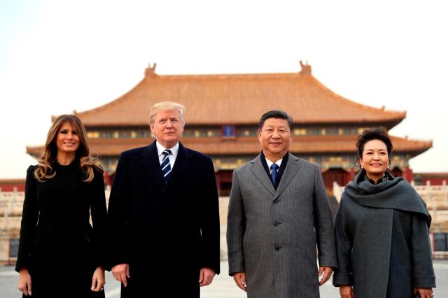 US President Donald Trump second left first lady Melania Trump left Chinese President Xi Jinping and his wife Peng Liyuan stand together as they tour the Forbidden City in Beijing Nov 8 2017 AP-Yonhap 