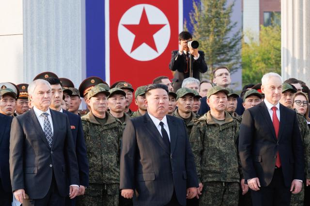 Russias Defence Minister Andrei Belousov North Koreas Supreme Leader Kim Jong Un and Russian State Duma Speaker Vyacheslav Volodin R-L take part in a wreath laying ceremony during the opening of a museum and memorial complex dedicated to the North Korean servicemen who took part in the liberation of Russias Kursk Region from the Ukrainian Armed Forces Courtesy of Russian Defence Ministry Press Office