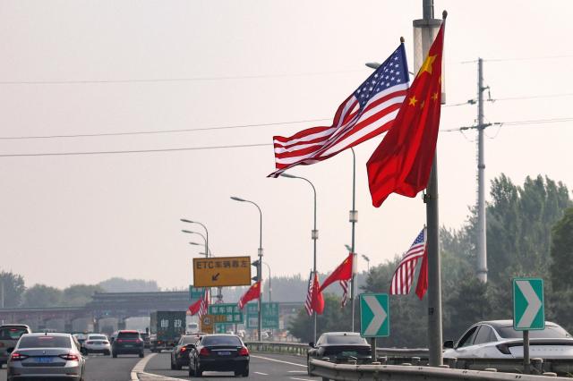 National flags of China and the United States flutter on a road ahead of the US President Donald Trumps state visit to China in Beijing China May 13 2026 Reuters-Yonhap 