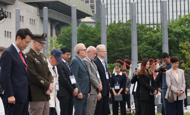People Power Party Seoul mayoral candidate Oh Se-hoon far left Korean War veterans and ambassadors observe a moment of silence during a dedication ceremony for the “Garden of Gratitude” at Gwanghwamun Square in Jongno-gu Seoul on May 12 2026 Yonhap 
