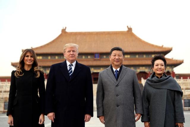 US President Donald Trump 2nd from left first lady Melania far left Chinese President Xi Jinping and his wife Peng Liyuan stand together as they tour the Forbidden City in Beijing in this file photo from November 2017 AP-Yonhap